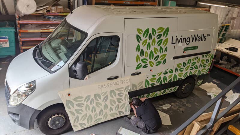 An image of the installation of the Living Walls van graphics.